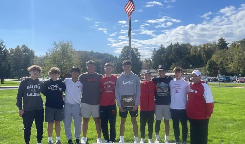 Golf team students holding trophy