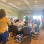 Staff and educators sitting at tables