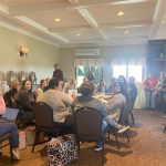 Staff and educators sitting at tables