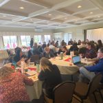 Staff and educators sitting at tables