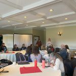 Staff and educators sitting at tables