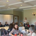 Staff and educators sitting at tables