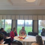 Staff and educators sitting at tables