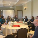 Staff and educators sitting at tables