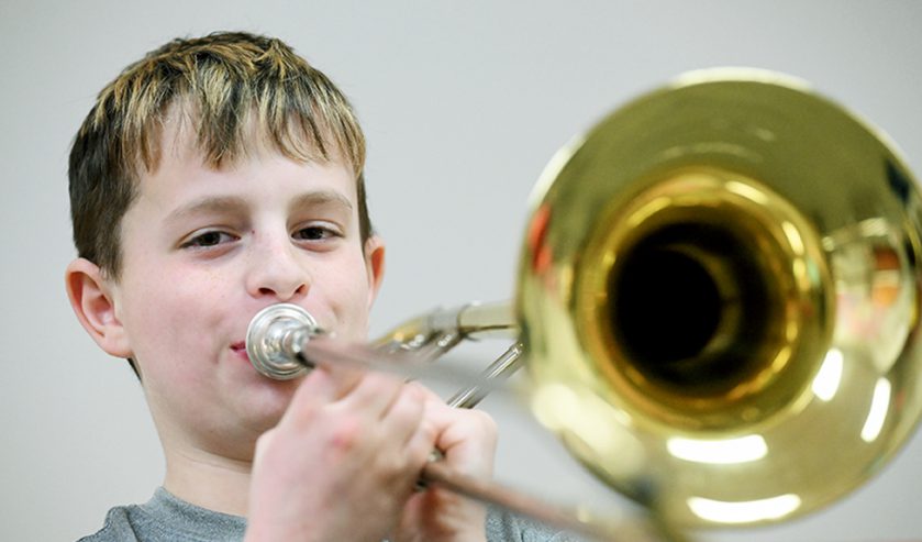 Elementary student playing trumpet