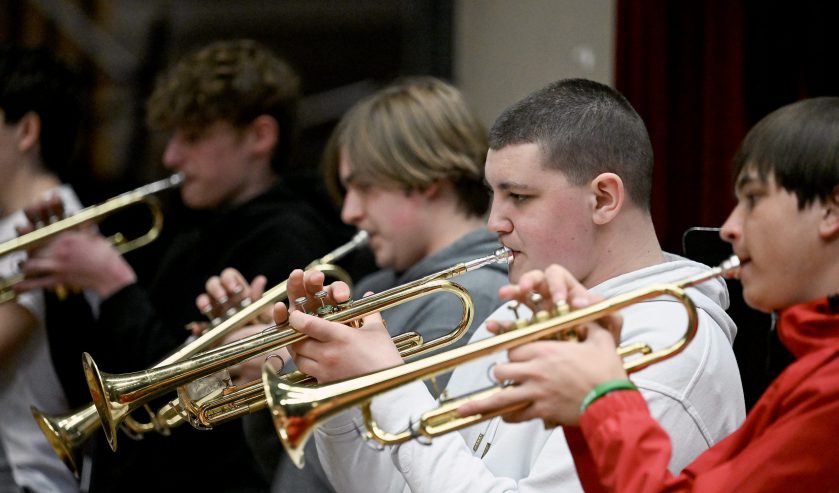 5 high school students playing trumpet